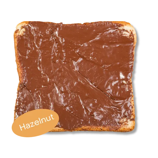 A generously spread toast with La Chambre's hazelnut spread, next to the jar